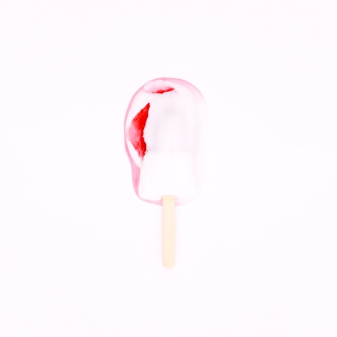 Color photo of a pink popsicle melting on a pink background.