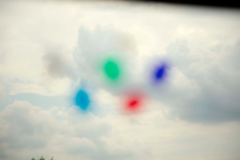 Photo of colorful out of focus (and unidentifiable) objects floating the sky.