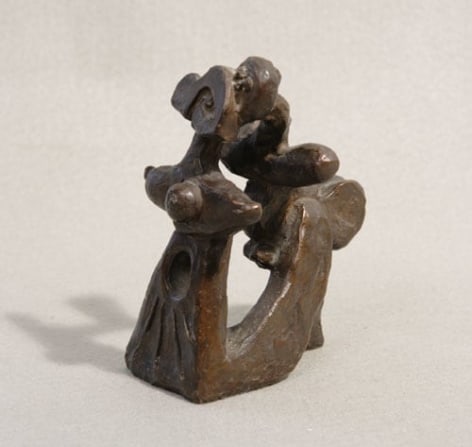 Abstract figurative bronze sculpture of a woman (left) that curves at the bottom to transform into the figure of a male adult or youth (right).