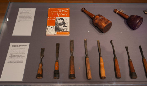 Close up image of the wooden sculpture tools and equipment featured in the exhibit.