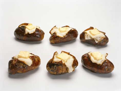 Six baked potatoes with butter based on the sculpture by Claes Oldenburg and then presented as a photograph
