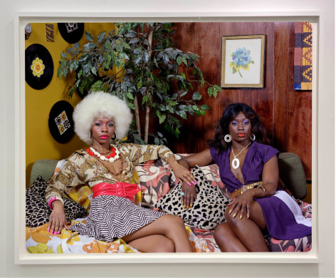 Mickalene Thomas,&nbsp;Kindred Spirits, Tamika and Qusuquzah Sitting on Couch, 2022. Archival pigment print, 48 x 60 inches.