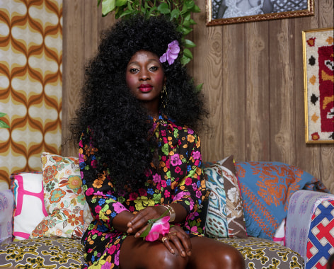 Mickalene Thomas,&nbsp;Portrait of Qusuquzah with Flower in Hair and Hand, 2022. Archival pigment print, 48 x 60 inches.