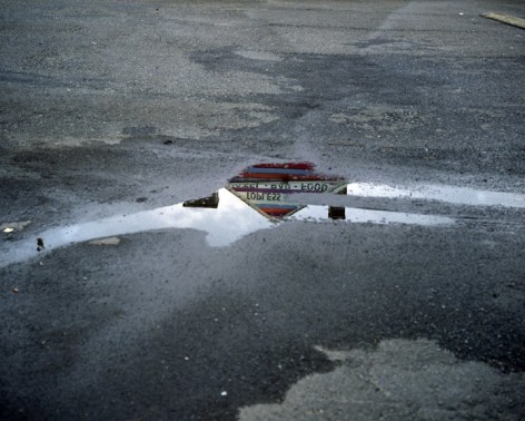 Topless bar reflected in puddle, Doylestown, Pennsylvania, 2010. Archival Pigment Print, Editions of 5. Available Sizes: 20 x 24 inches, 30 x 40 inches, and 40 x 50 inches