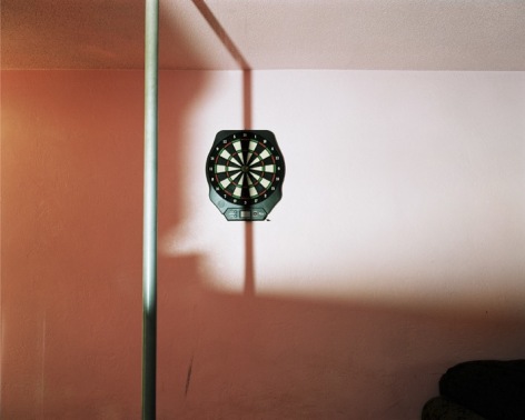 Dartboard and stripper pole at swinger&#039;s club, Daytona Beach, Florida, 2005. Archival Pigment Print, Editions of 5. Available Sizes: 24 x 20 inches, 40 x 30 inches, and 50 x 40 inches