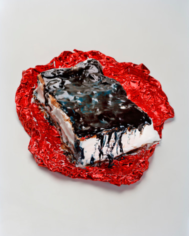 Photograph by Sharon Core. An ice cream sandwich and red foil wrapper arranged to look like the sculpture by Claes Oldenburg.