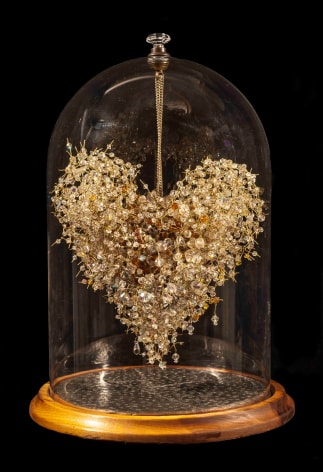Karin Broker  a stilled specimen, 2011-12  wired heart hanging from top of globe with round base  17 x 9.5 x 9 inches  Private Collection