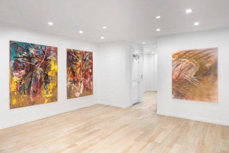 white gallery space with art on walls