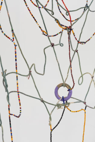 detail of a rope artwork with beads