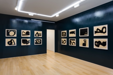 installation view of india ink drawings in a blue room
