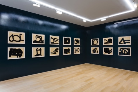 installation view of india ink drawings in a blue room