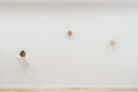 installation view of a white gallery with various sculptures