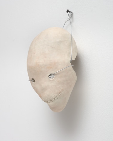 a wired ceramic skull