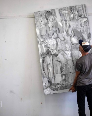 image of a man moving a silver painting