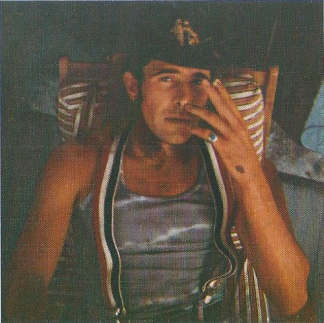 image of a man smoking in suspsenders