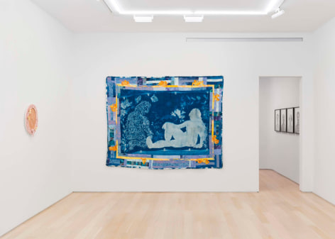 installation view of paintings in a white room