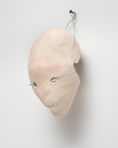 ceramic skull with a wire through the eyes