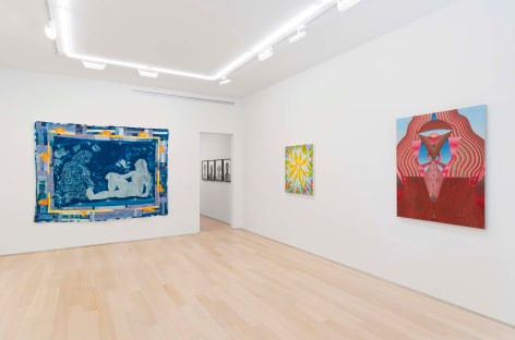 installation view of paintings in a white room