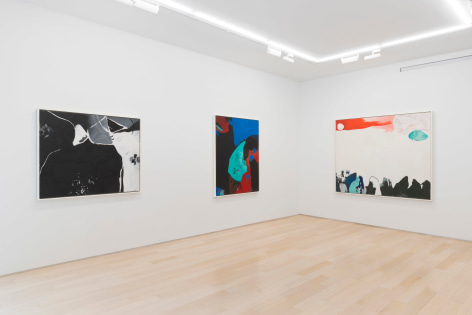 installation view of multiple paintings in a white room