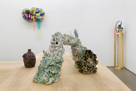 An installation view of the group exhibition &quot;Morph&quot;. There are sculptures on a table and on the wall in the gallery