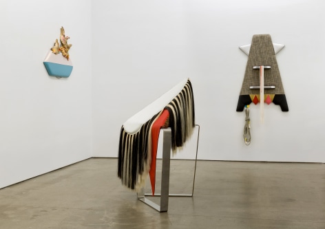 Installation view of Trish Tillman's exhibition &quot;Stage Diver&quot;, which shows plush sculptures on the walls and standing on the floor.