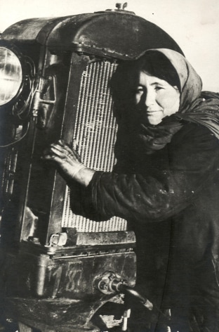 Woman Hugging Tractor, ca. late 1920s-early 1930s