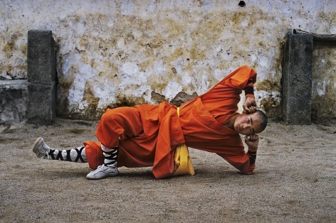 Steve McCurry, Young monk practicing Shaolin, one of the oldest styles of Kung Fu, Shaolin Monastery, Henan Province, China, 2004, 50.8 x 61 cm (20 x 24 inches)