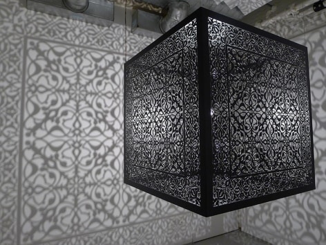 Anila Quayyum Agha, Shimmering Mirage, 2016, lacquered steel and halogen bulb, 36 x 36 x 36 inches/91.4 x 91.4 x 91.4 cm