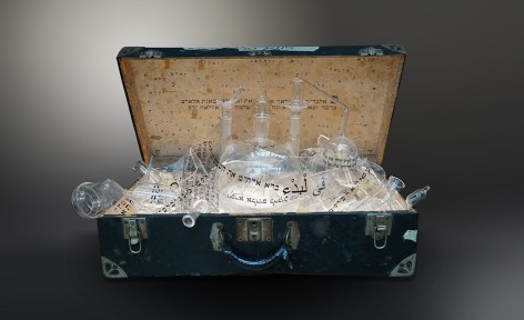 The Genesis Series - Genizah I, 2022, vintage suitcase; shattered glass and shards with engraved, appliqué and printed text; and light panel, 45.7 x 76.2 x 40.6 cm (18 x 30 x 16 inches)
