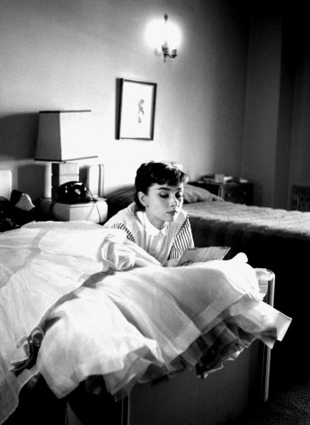 Audrey Hepburn, on her first trip to Hollywood, reads letters from home in her hotel room after a long day at Paramount Studios, Chapman Hotel, Los Angeles, 1953, Archival Pigment Print