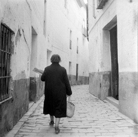 Woman walking with basket from behind, Sevilla, Spain, November, 1956, Silver Gelatin Photograph