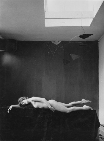 Dorothee Blank lying under Calder mobile in Agn&egrave;s&rsquo;s studio, rue Daguerre, Paris, ca. 1958, Silver Gelatin Photograph, Ed. 1/15