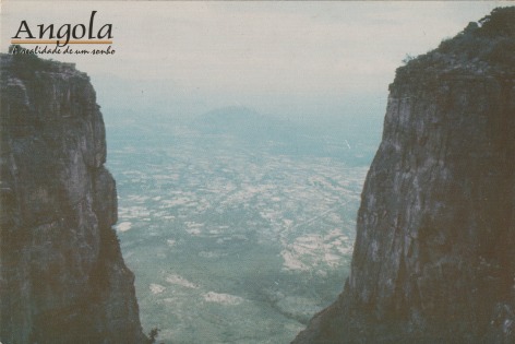 A postcard Ana Maria Jeremias kept from an Angolan mountain landscape, where the phrase &#039;Angola: The Reality of a Dream&#039; can be read, 2024