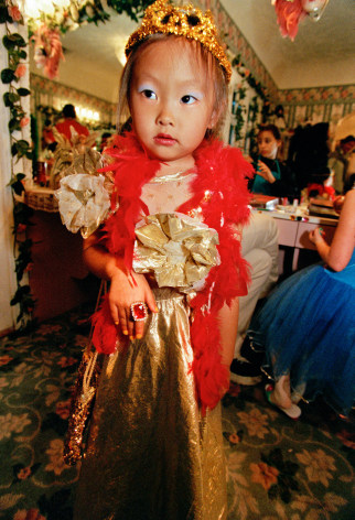 Elita, 6, at a birthday party where girls have their hair and make-up done, play dress up, model in a fashion show, and have a tea party, Hollywood, California, Archival Pigment Print