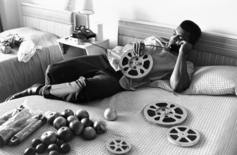 Ali Looking at Film Reels, Miami Beach, FL, 1970, Silver Gelatin Photograph