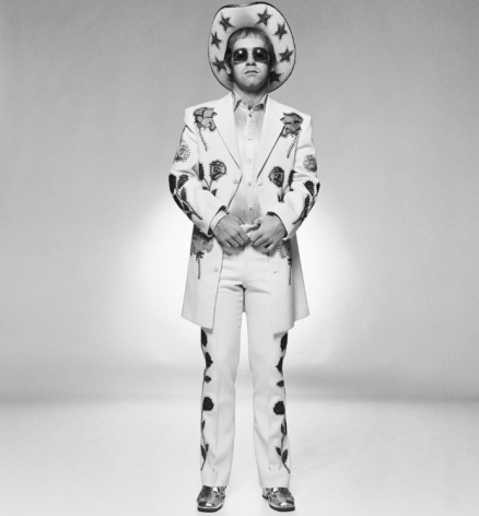 Terry O&#039;Neill Elton John wearing a floral applique cowboy suit designed by Nudie Cohn for the cover of the &quot;Rocket Man&quot; single, 1972