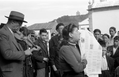 Man playing fiddle and woman reading to group, Viana Do Castelho, Portugal, 1956