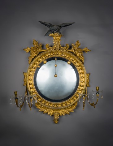 &quot;Neo-Classical Convex Girandole Mirror with Candle Arms,&quot; about 1810. American, probably Salem, Massachusetts. Eastern White Pine (Pinus strobus), gessoed and gilded, and partially ebonized, with convex mirror plate, glass drip pans, blown and cut, glass prisms, gilt-brass candle cups and bobeches, and brass chain 43 in. high, 38 in. wide, 10 5/8 in. deep