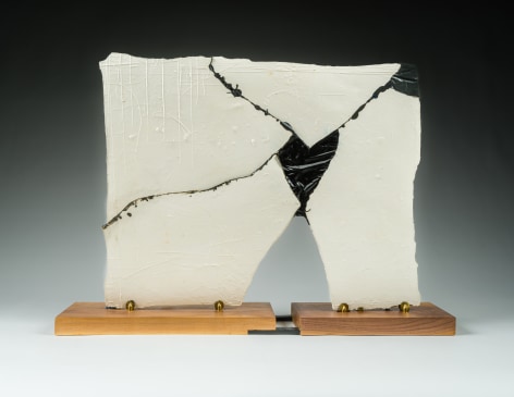 a ceramic slab which has been broken and glued back together with black epoxy by Maria Elena Gonzalez