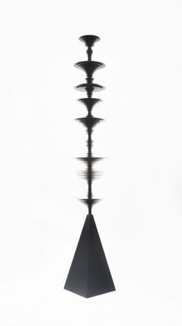 a sculpture by Elizabeth Turk of black aluminum discs layered and arranged to resemble a sound wave and a modernist abstraction