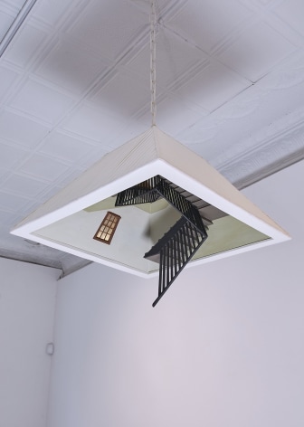 a sculpture of an overhead lamp with a descending stairwell hidden inside