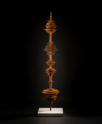 a sculpture by Elizabeth Turk of wood discs layered and arranged to resemble a Modernist abstraction and a sound wave