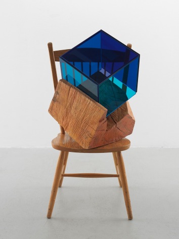 a sculpture by Sarah Braman of a dining chair fused with multi-colored glass panels