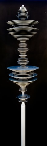 a sculpture by Elizabeth Turk of aluminum discs layered and arranged to resemble a Modernist abstraction and a sound wave