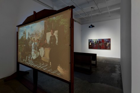 Pamela Phatsimo Sunstrum, Mumbo Jumbo and the Committee (2022). Installation with wood, film, and painting components Running time: 56 seconds Painting, overall: 48 1/8 x 96 in (122 x 244 cm)