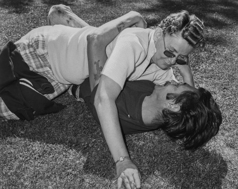 Couple lying on the ground in a park. Photograph by Mike Smith