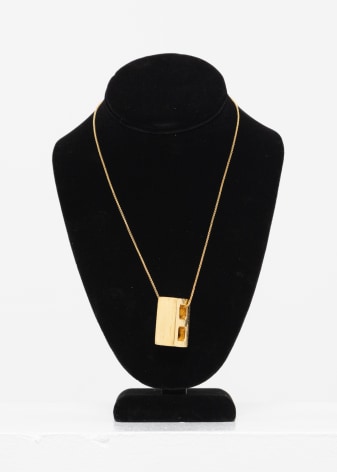 Gold necklace with gold cinder block pendant, by Randy Shull