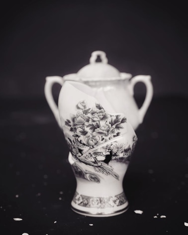 Black and white photograph of broken urn, by James Henkel