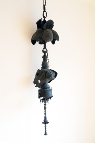 a black cast paper hanging with a foliage patter