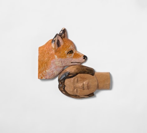 Wood sculpture of human head and fox head, by Sachiko Akiyama
